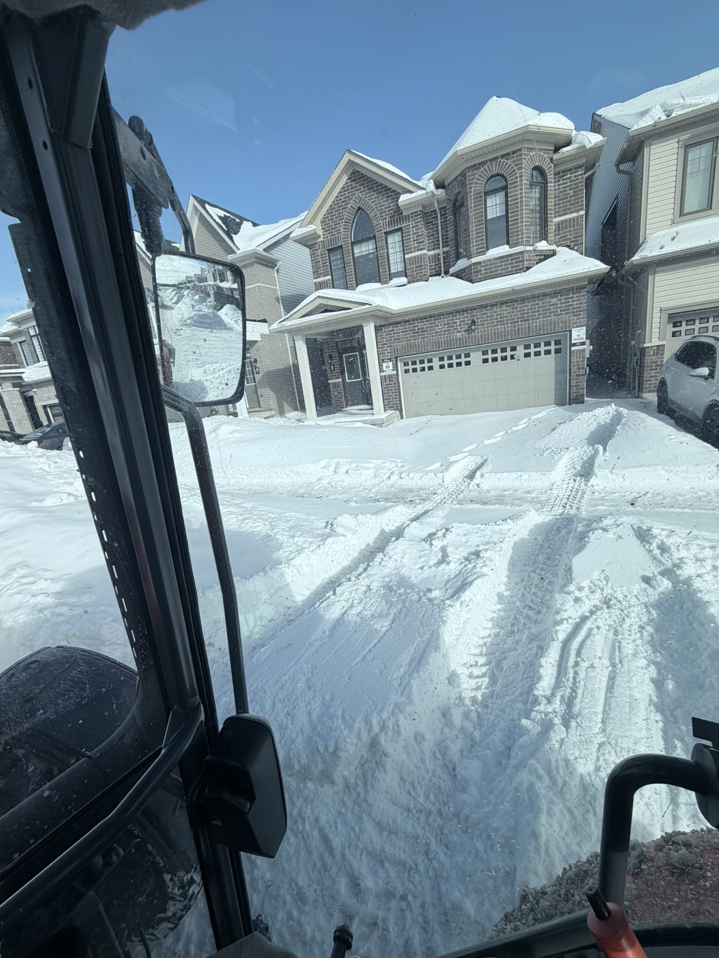 Snowforce clearing a residential driveway after a winter storm