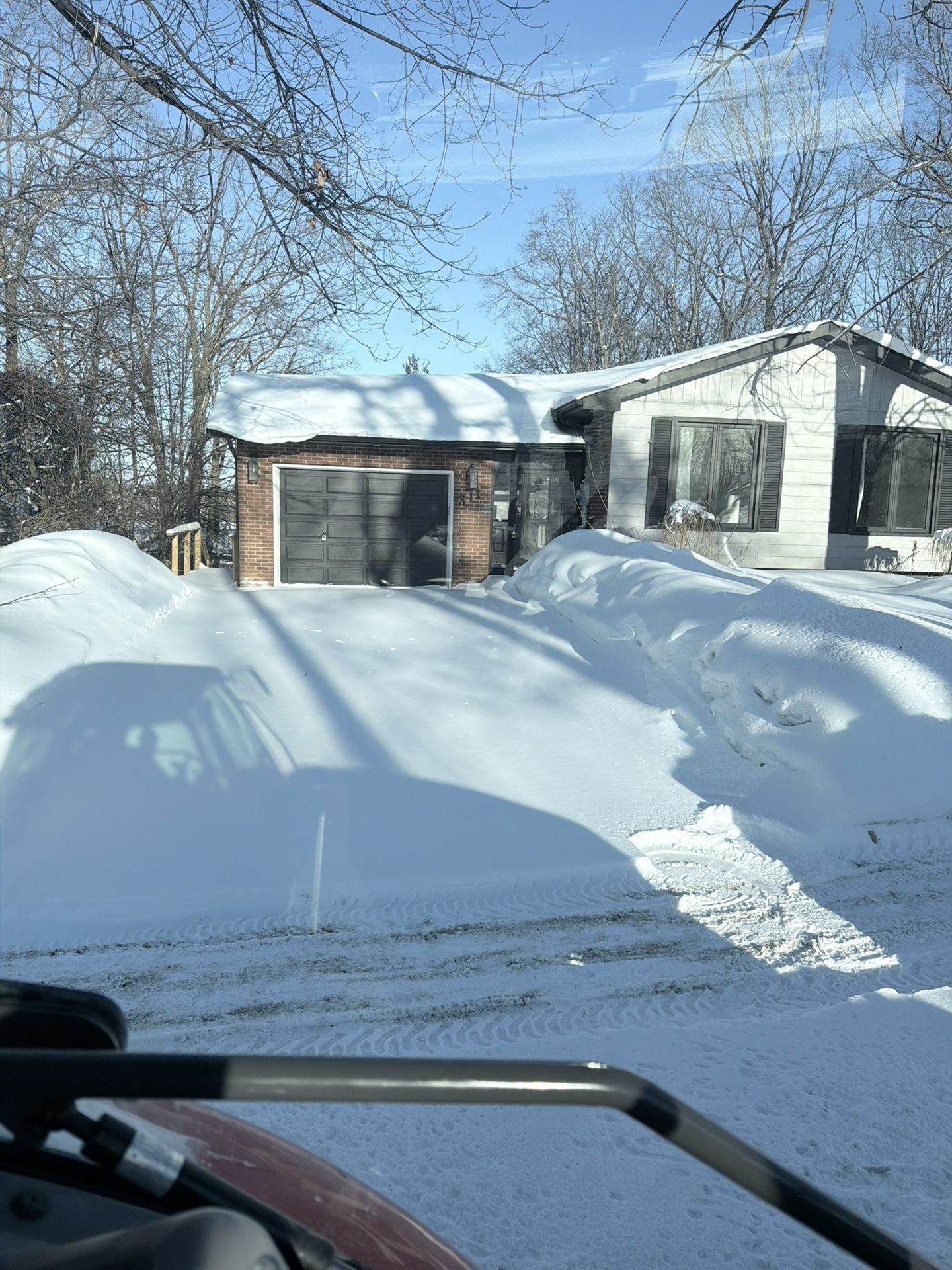 Snowforce operator plowing a Barrie driveway